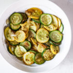 zucchini and yellow squash in a white serving dish