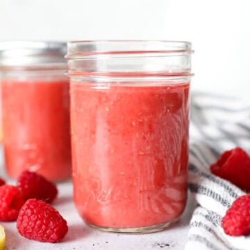 Close up front view of raspberry vinaigrette dressing in a mason jar.