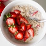 Strawberry Steel Cut Oatmeal with almond milk and chia seeds in a white bowl