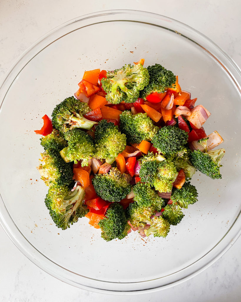 Broccoli, Bell Peppers and Onion in a large glass bowl