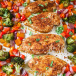 Chicken Breast and Vegetables on a parchment lined sheet pan