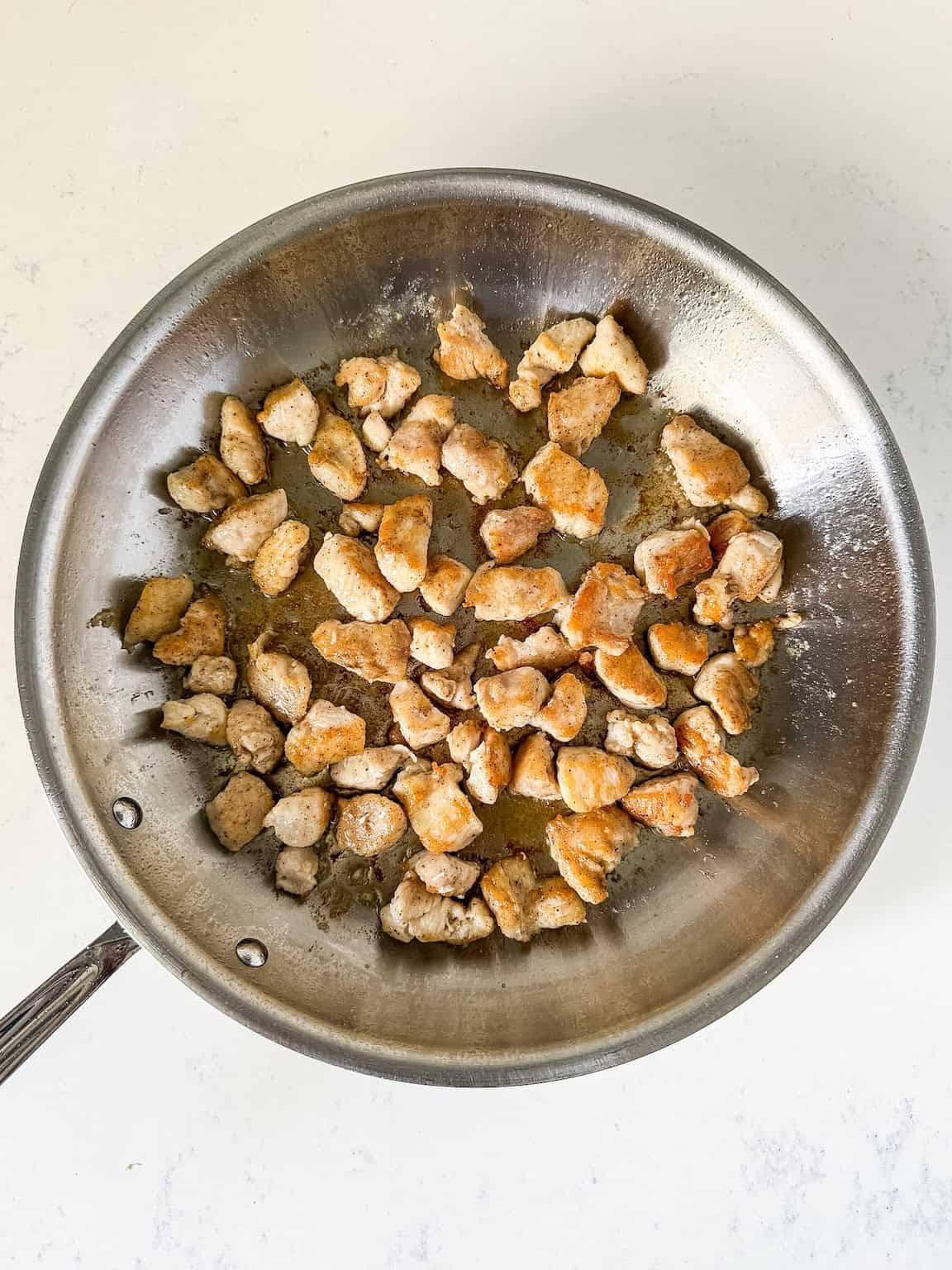 cooked chicken pieces in a large skillet.