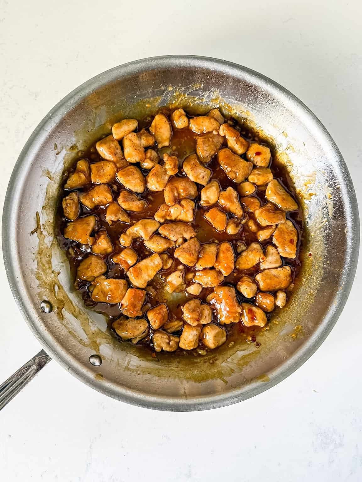 Cooked honey garlic chicken in a large skillet
