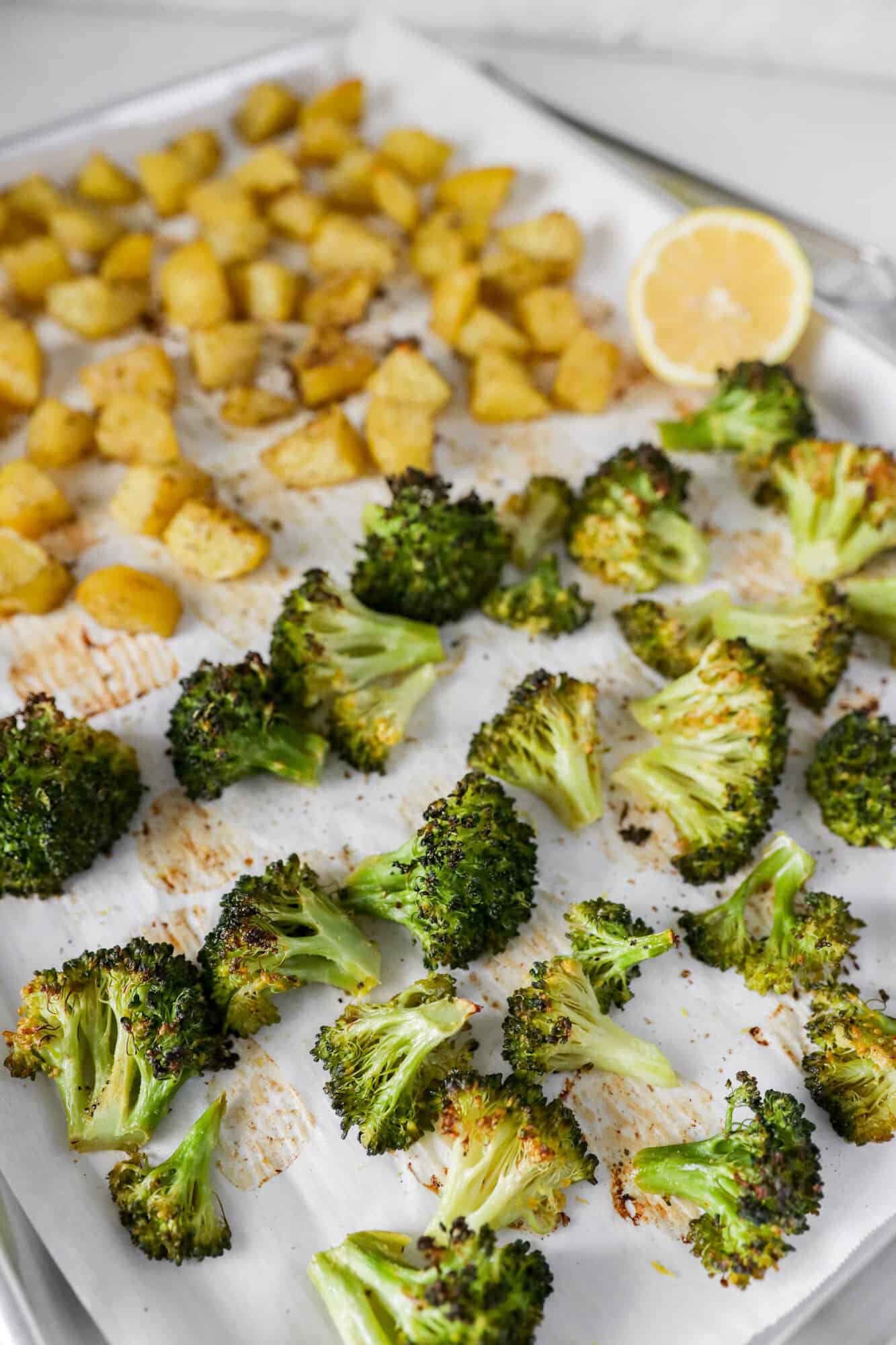 Roasted Broccoli and Potatoes on a sheet pan with lemon zest to garnish