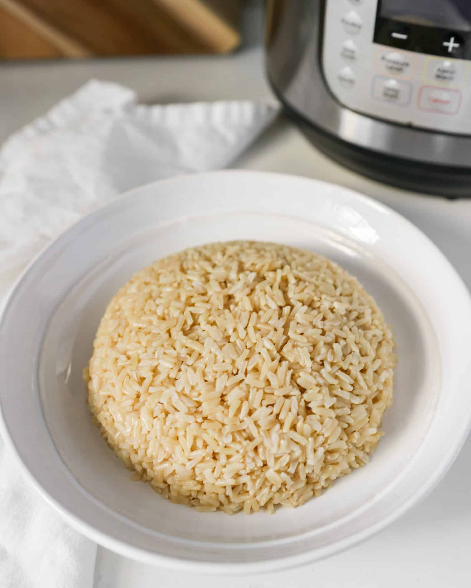 Brown Jasmine Rice in a white serving dish on a white counter