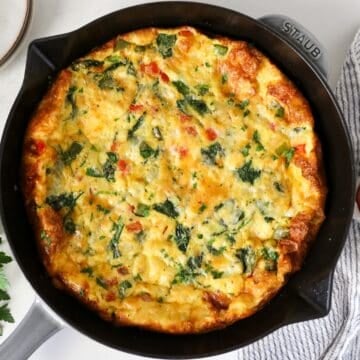 Overhead view of a vegetable frittata in a skillet.