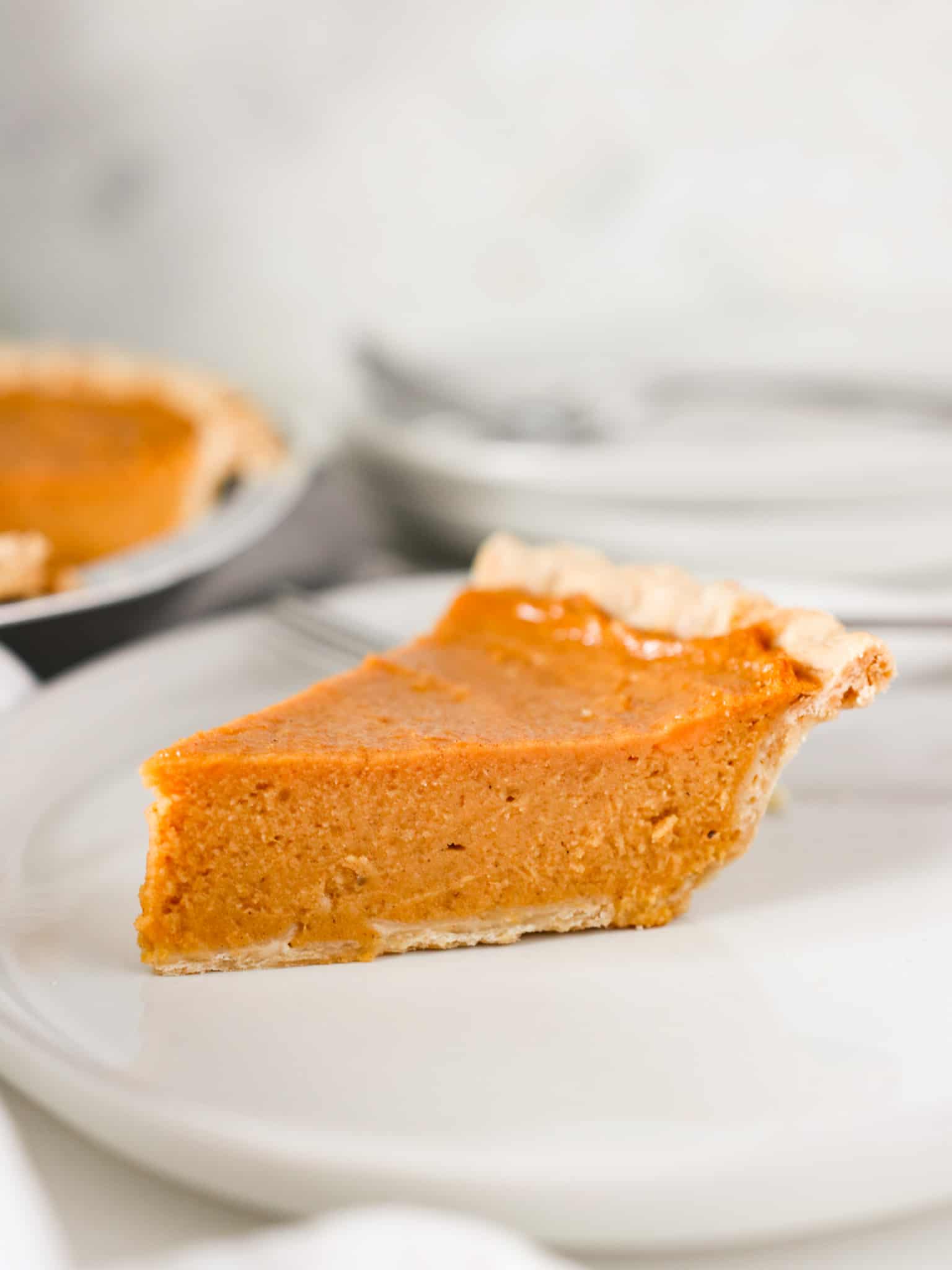 Side view of a slice of brown butter sweet potato pie.