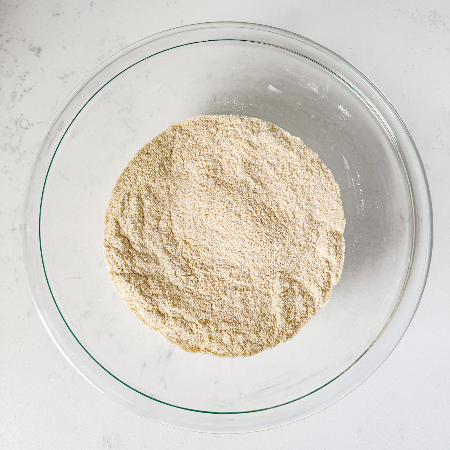 Cornbread dry ingredients mixed together in a glass bowl.