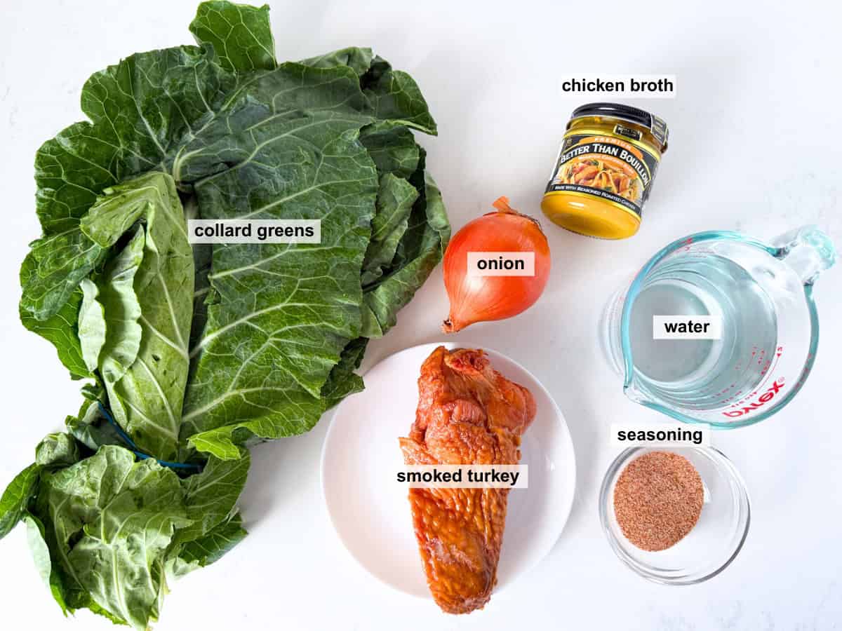 Overhead view of ingredients for collard greens recipe on a white countertop.