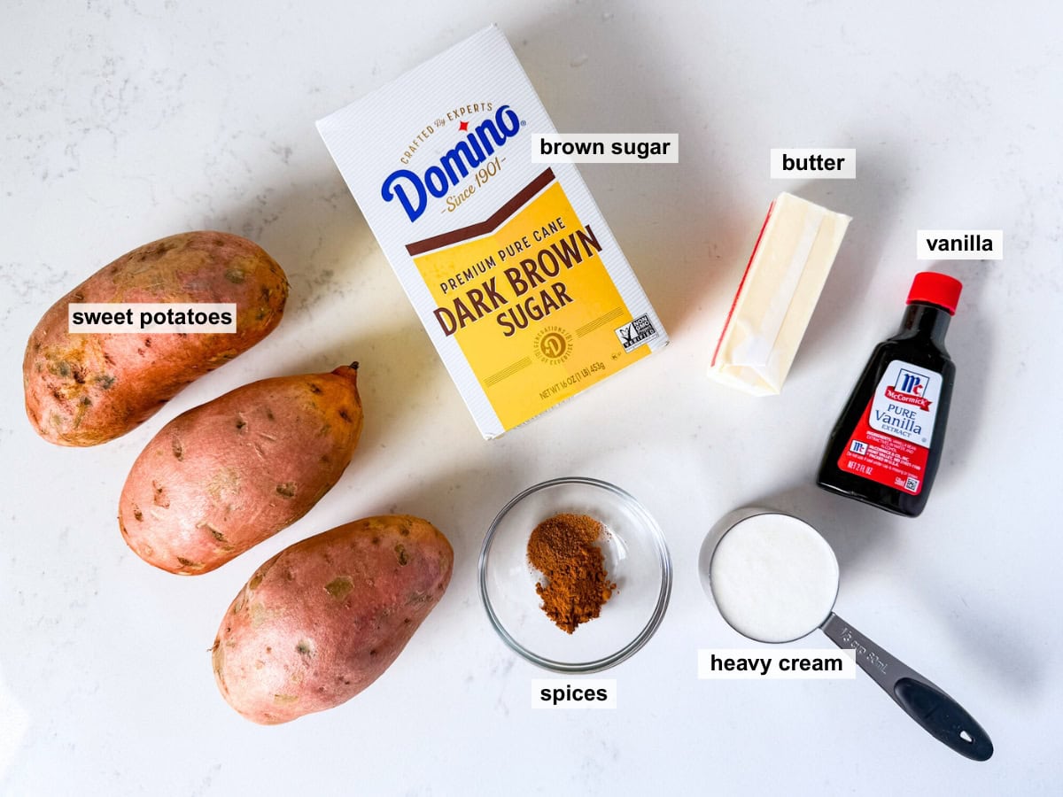 Overhead view of ingredients for mashed sweet potatoes on a white countertop.