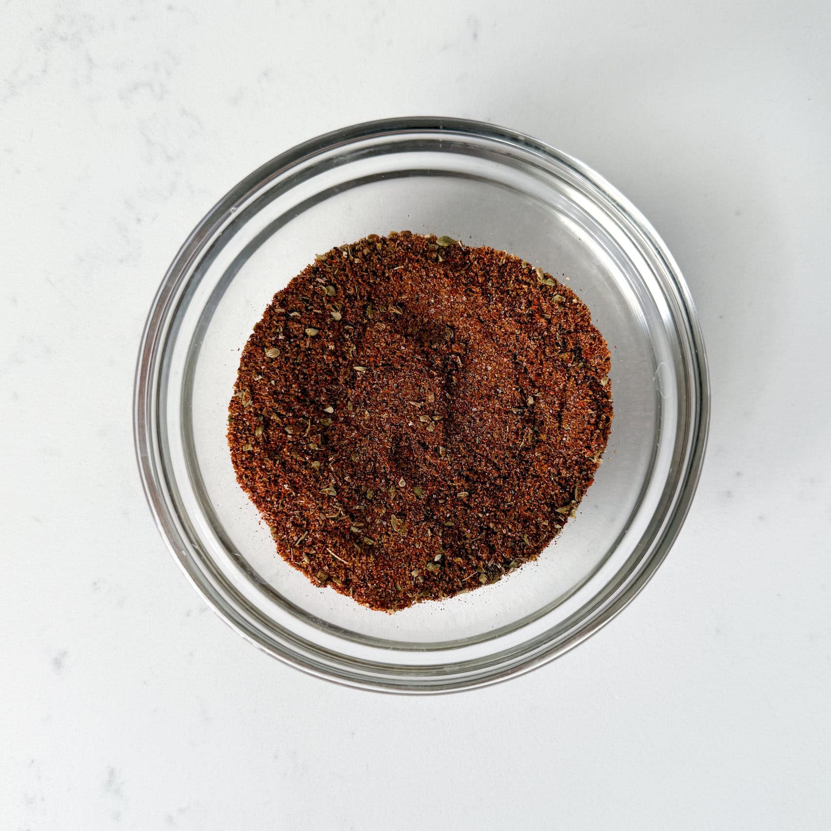 White chicken chili spices mixed together in a glass bowl.