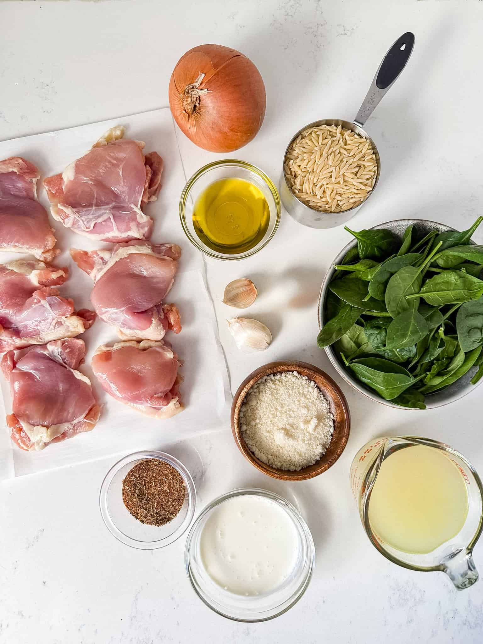 Overhead view of ingredients for one pan chicken and orzo.