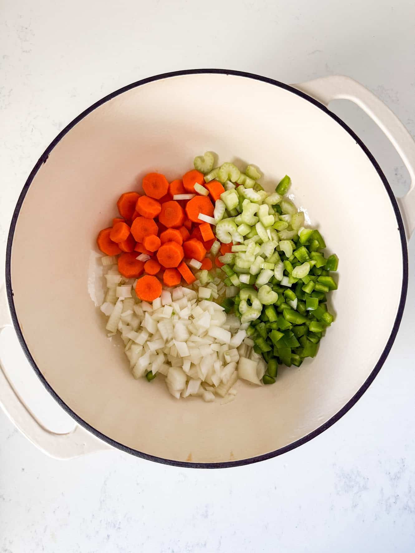 Diced vegetables in a dutch oven pot.