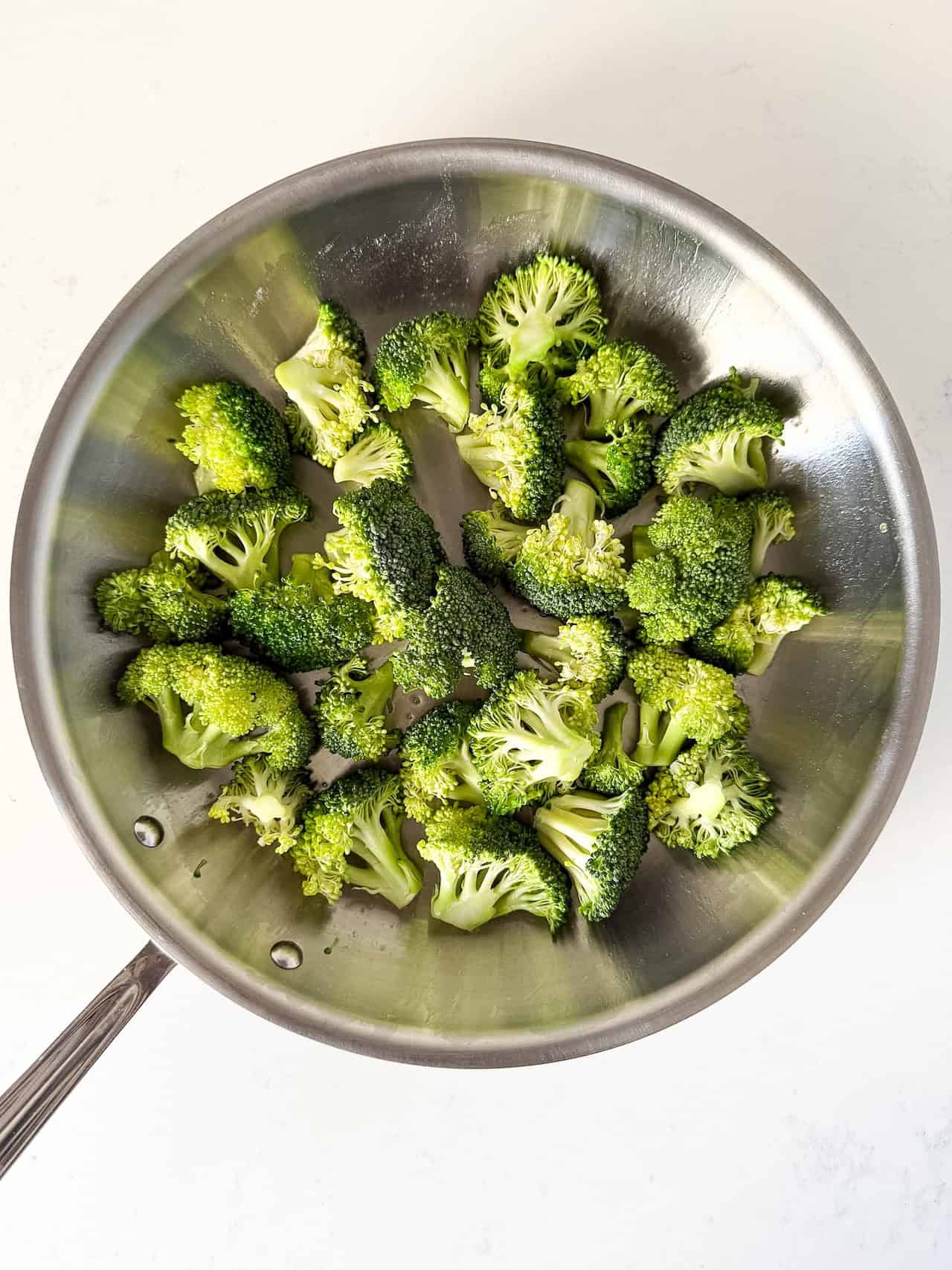Broccoli cooking in a skillet