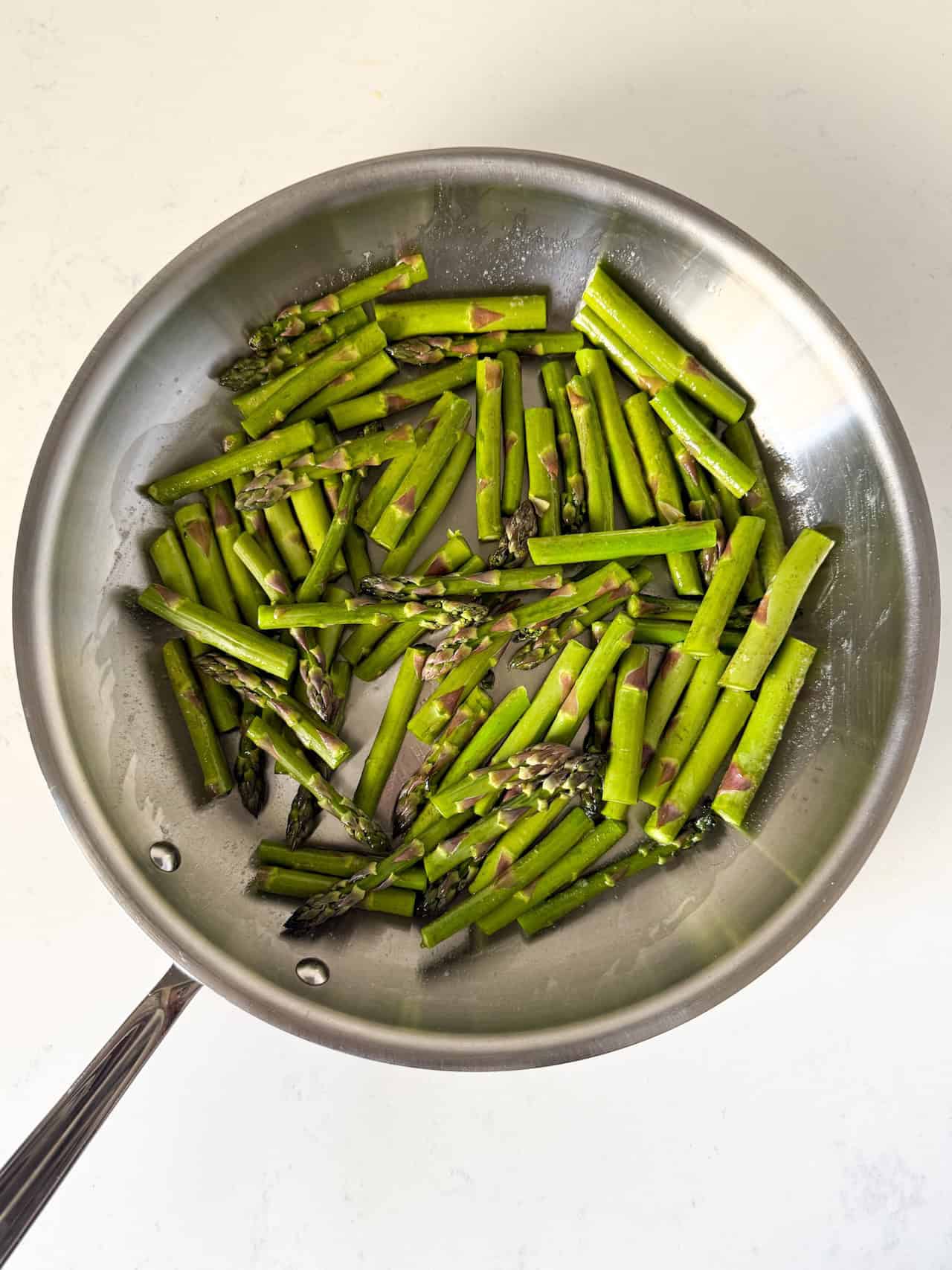 Asparagus added to large skillet