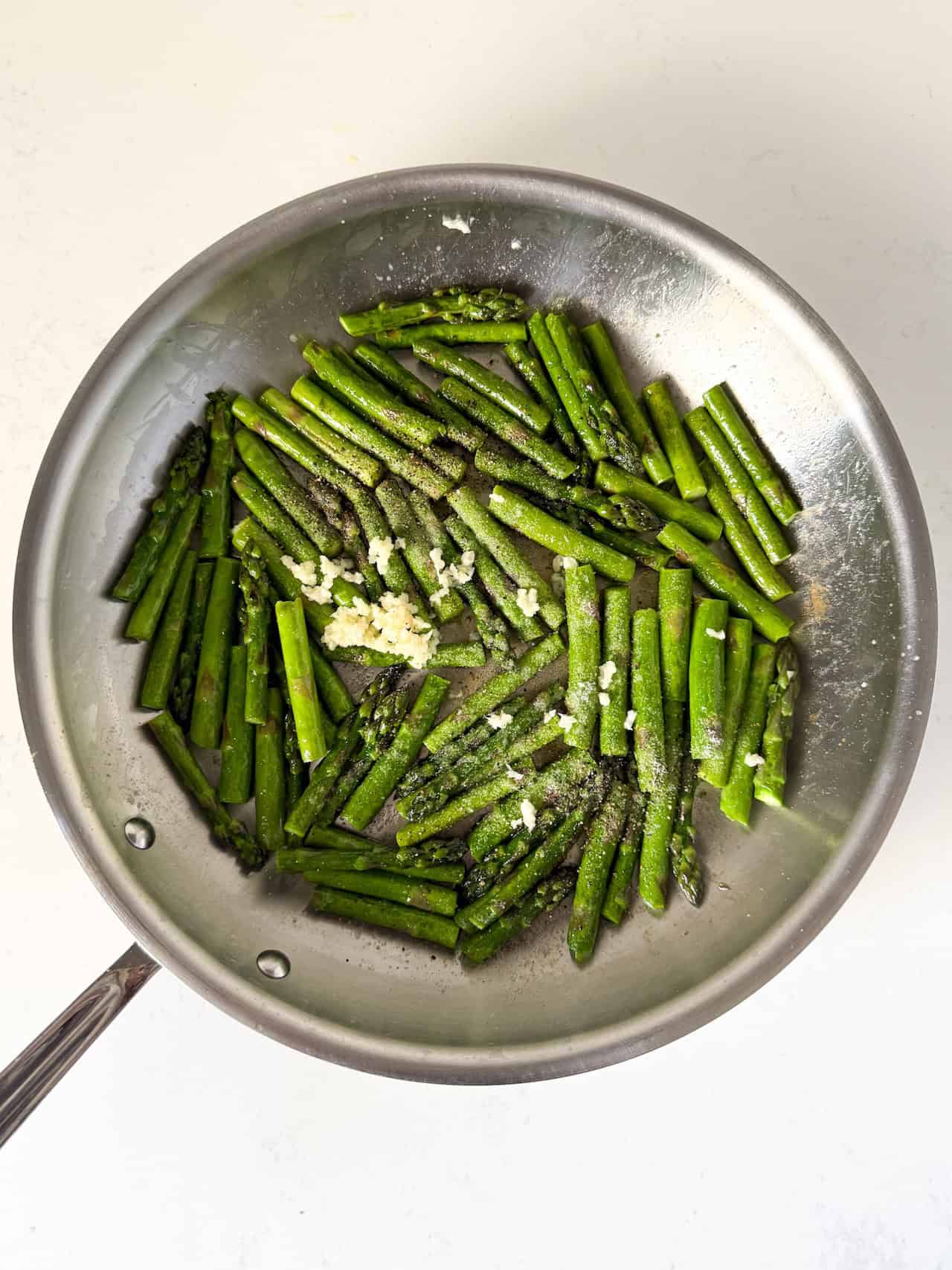 Garlic, salt, and black pepper added to skillet
