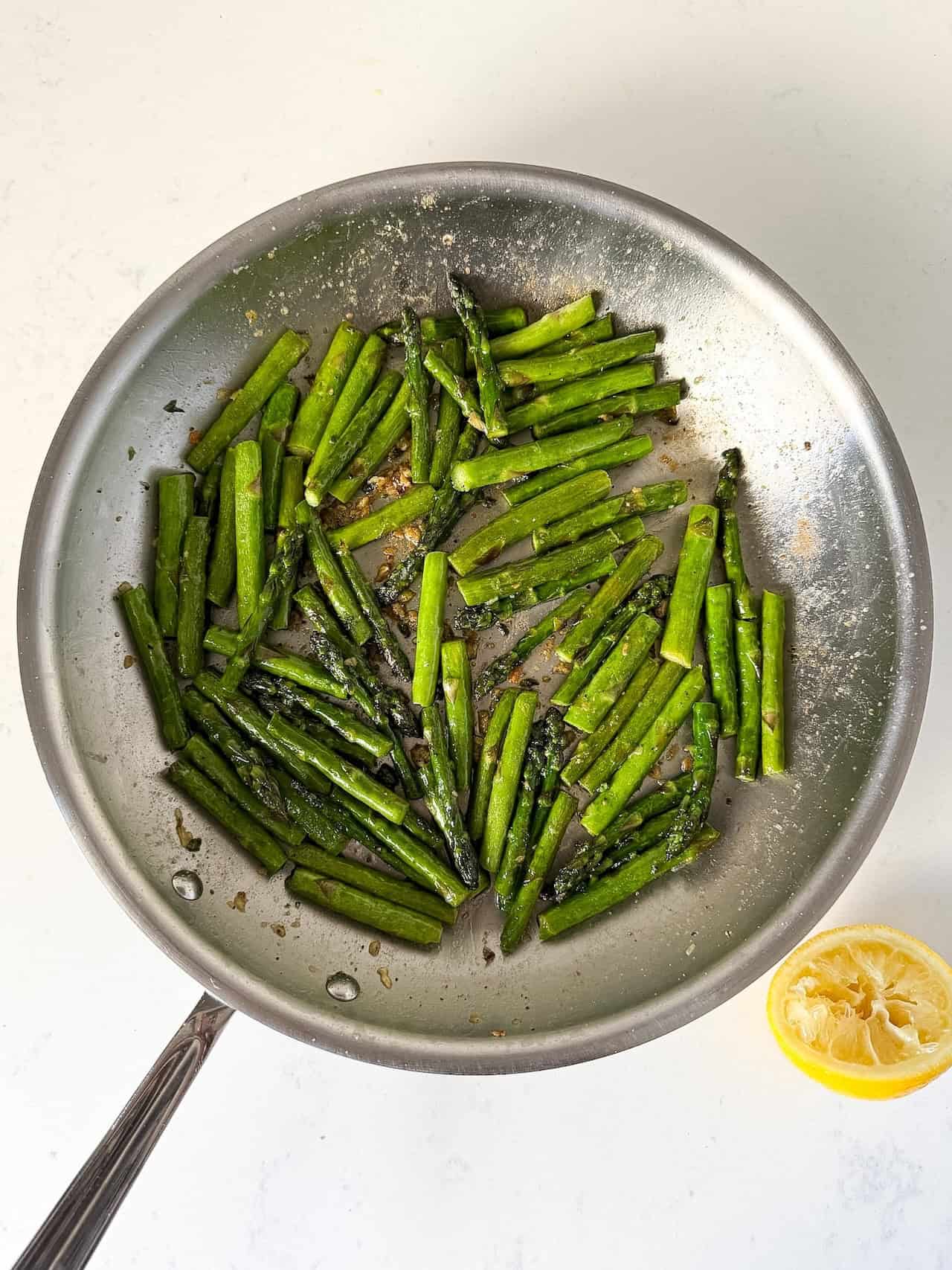 Finished sautéed asparagus in skillet.
