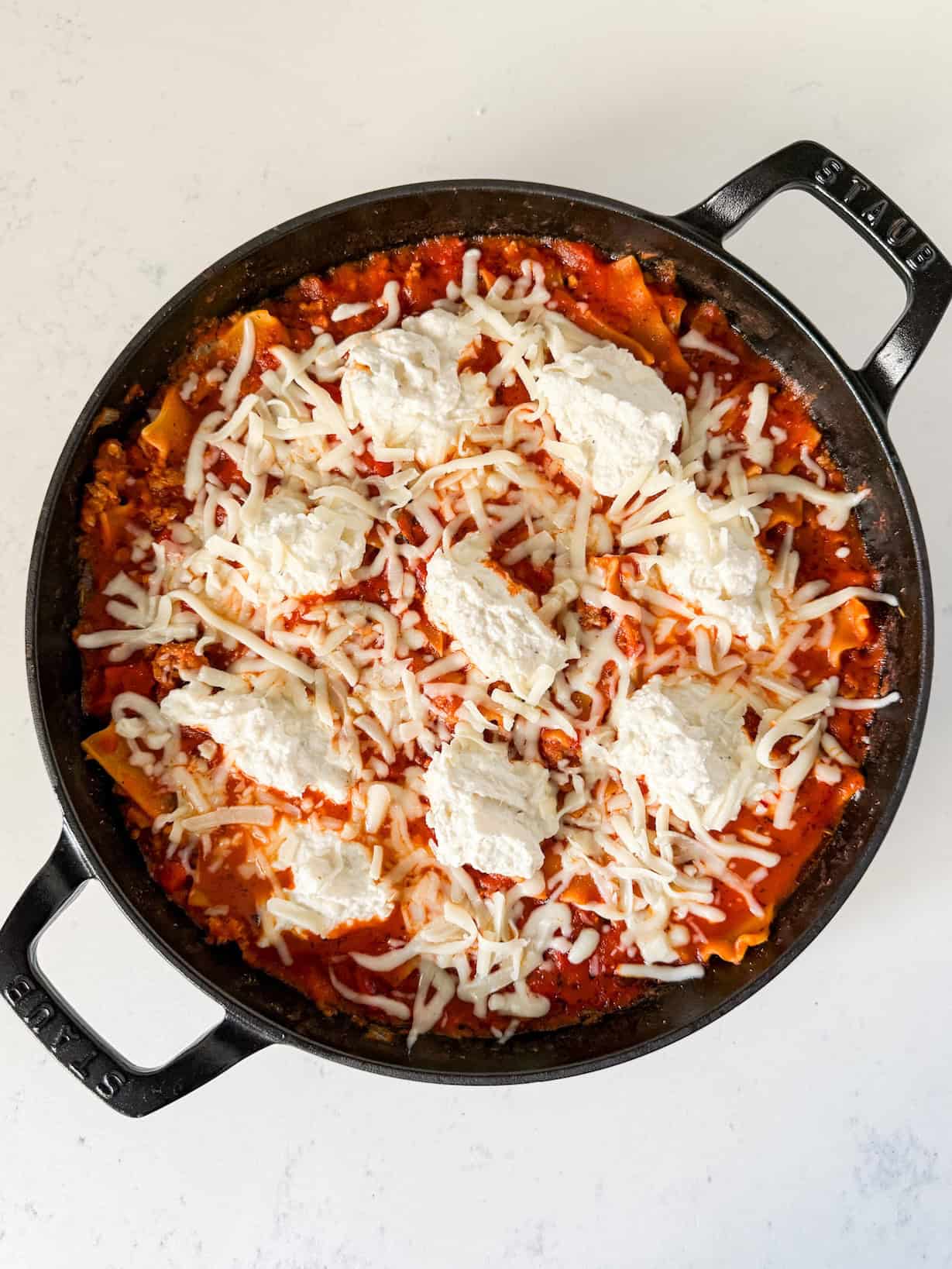 Ricotta cheese topping added to the skillet.