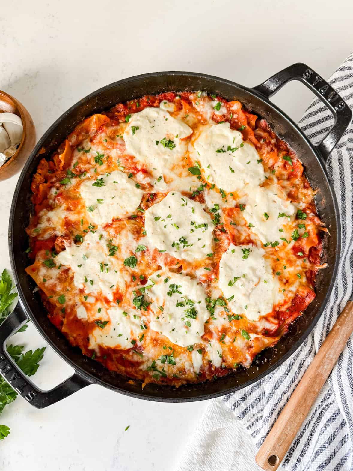 Cooked skillet lasagna garnished with parsley.