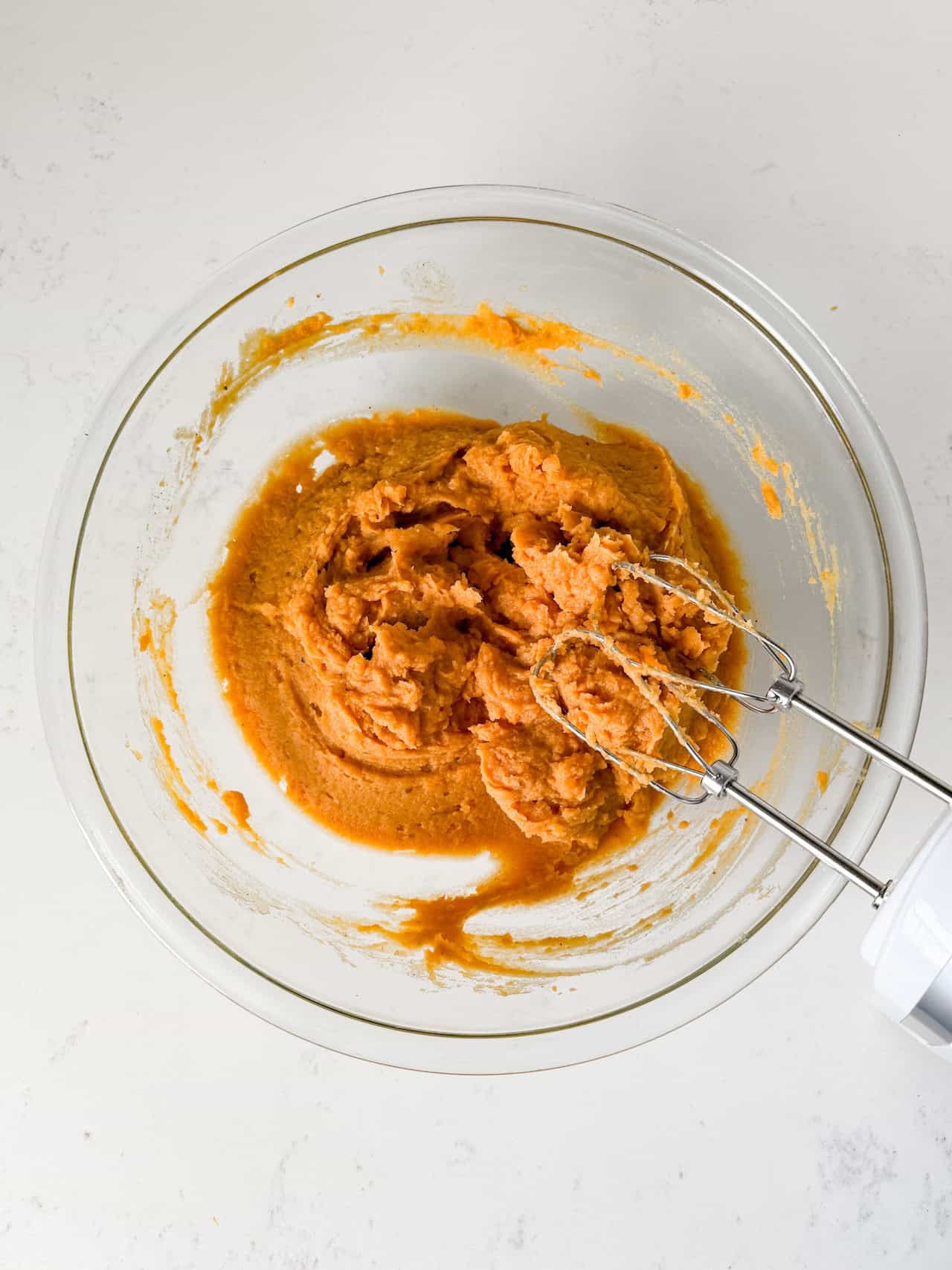 Sweet potatoes mixed together with the wet ingredients.