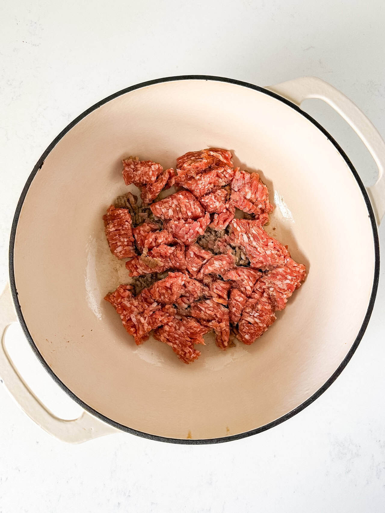 Italian sausage browned in a dutch oven.