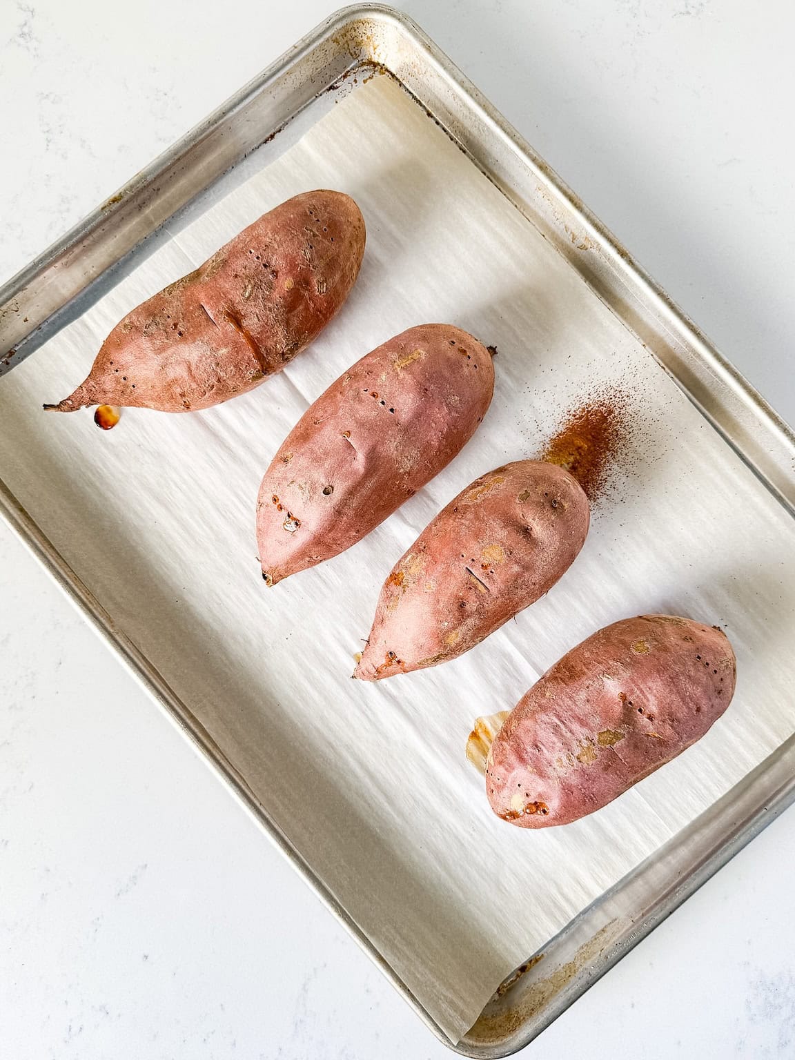 Baked sweet potatoes on a baking sheet