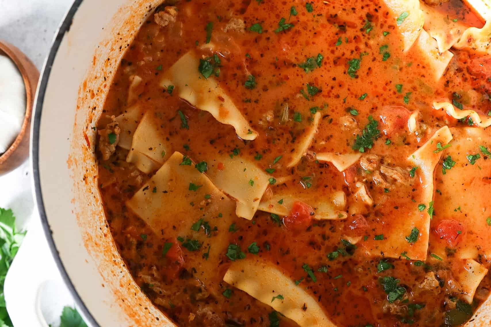 Overhead view of lasagna soup in a dutch oven.